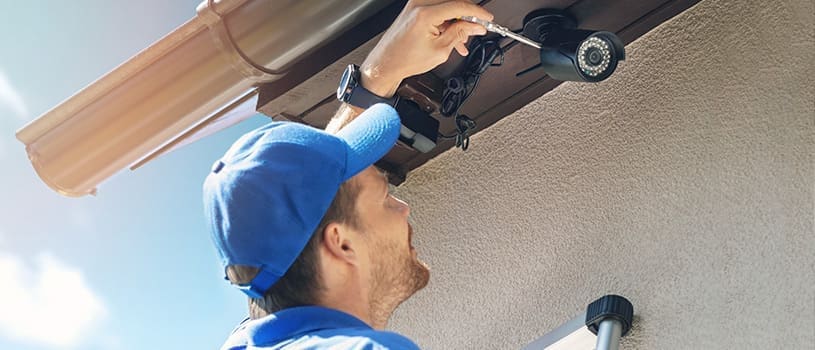 HOA security: 8 Easy Ideas To Improve Safety 2 man fixing hoa security camera