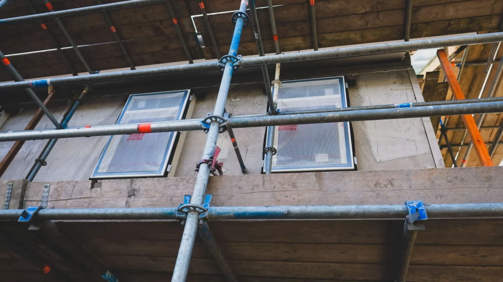 HOA Reserve Studies – What You Need to Know 1 Scaffolding on a building with windows and doors. Representing HOA reserve studies