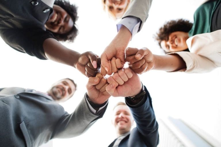 New HOA Board Members - group of people bumping fists