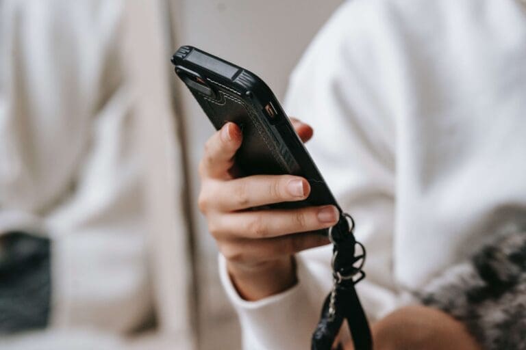 picture of a hand holding a black phone - text messages hoa condo